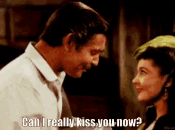 a man and a woman are looking at each other and the woman is asking the man if he can really kiss her now .