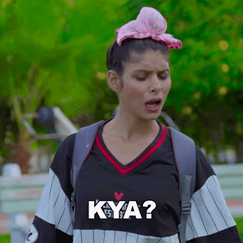 a woman with a pink bow on her head is wearing a shirt that says kya ?