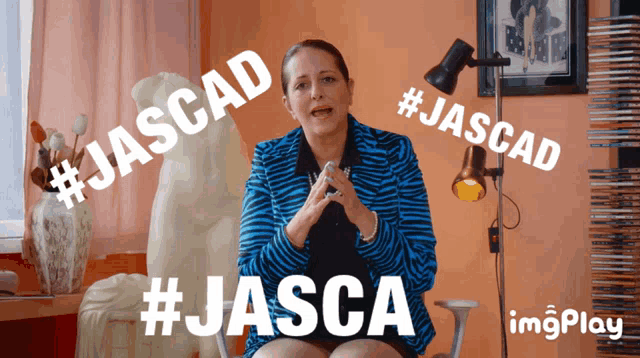 a woman in a zebra print jacket is sitting in front of a lamp and says #jascad #jasca and #jascad