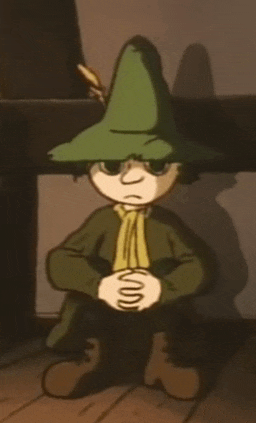 a cartoon character is wearing a green hat and sitting on the floor .