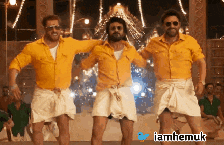 three men in yellow shirts and white shorts are dancing in front of a crowd with a hashtag iamhemuk