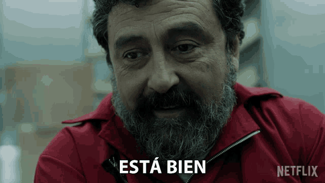a man with a beard is wearing a red jacket with netflix written on it