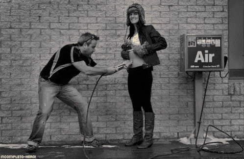 a man is pumping a woman 's belly with an air pump