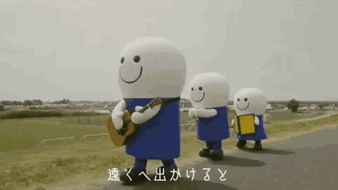 a group of mascots are walking down a road with one holding a guitar