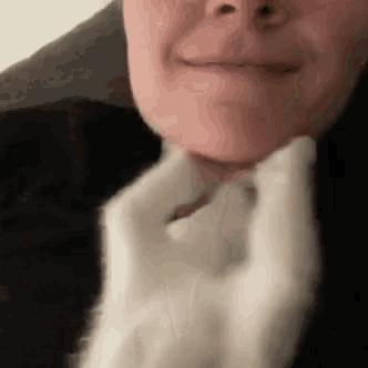 a close up of a person 's face with a white glove around their neck .