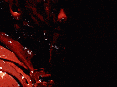 a close up of a person 's face with blood coming out of their mouth