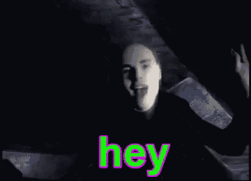 a man in a black shirt is waving his hand and the word hey is visible