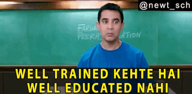 a man in a blue shirt is standing in front of a green chalkboard with the words well trained kehte hai well educated nahi