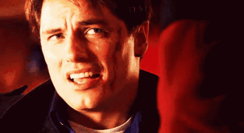 a close up of a man making a funny face with his mouth open .