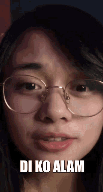 a close up of a woman wearing glasses with the words di ko alam above her