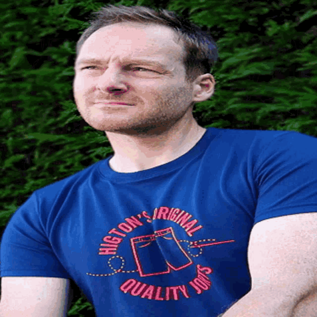 a man in a blue shirt that says hicton 's original quality jeans