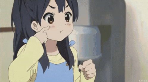 a little girl is making a funny face and pointing at her nose .