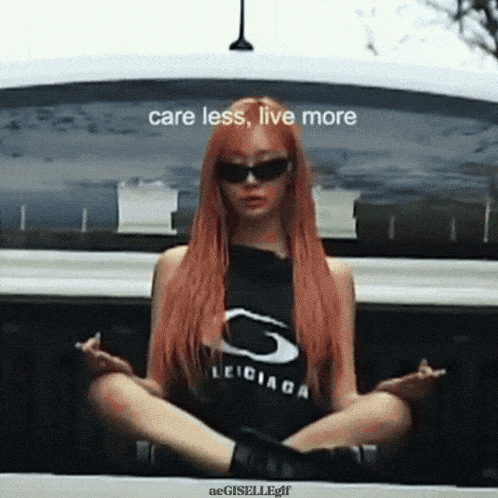 a woman with red hair is sitting in the back of a car with the words " care less live more " on the bottom