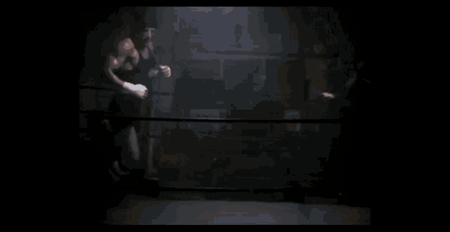 a man in a boxing ring with a black shirt on