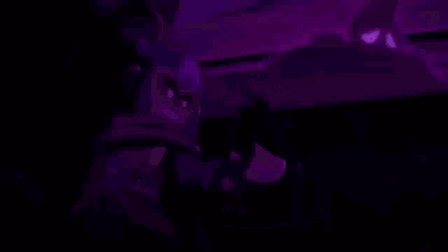 a purple cartoon character with glowing eyes is standing next to a purple cartoon character with a sad face .