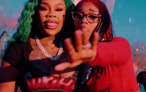 two women are posing for a picture and one has green hair and the other has red hair