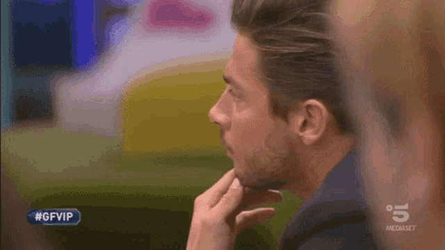 a close up of a man 's face with #gfvip written on the bottom
