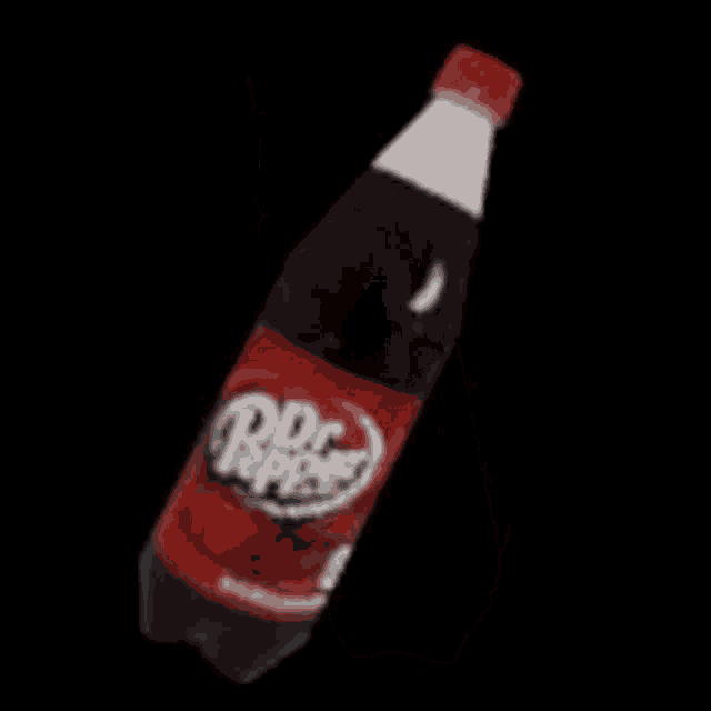 a bottle of soda with a heart on it is floating in the air .