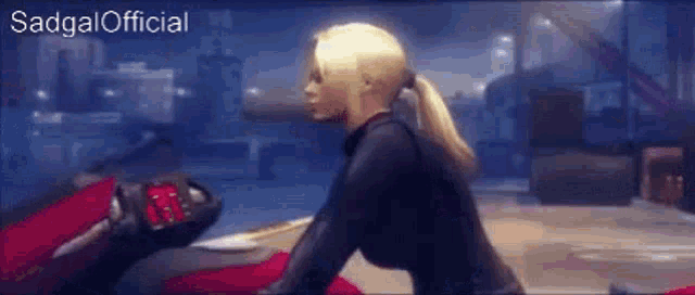 a woman in a black suit is sitting on a red motorcycle .