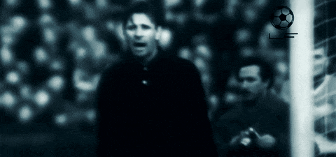 a blurry picture of a soccer player with a soccer ball in the background