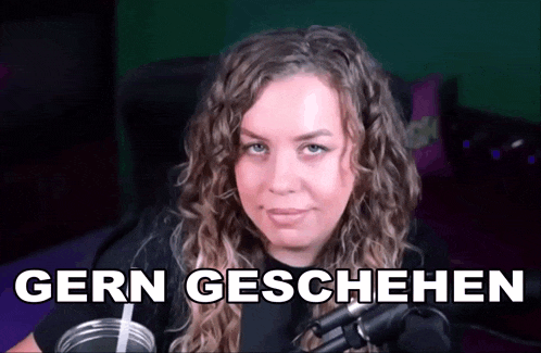 a woman sitting in front of a microphone with the words gern geschehen written on the bottom