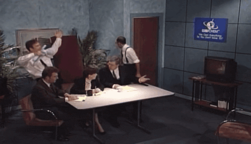 a man in a suit and tie is talking to another man