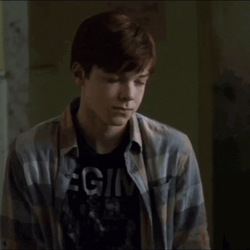 a young man wearing a t-shirt with the word begin on it