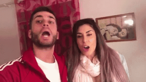 a man and a woman are standing next to each other in a room .