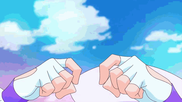 a person 's hands are visible in front of a blue sky