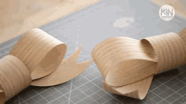 two pieces of wood are sitting on a cutting board with the letters kin on the bottom