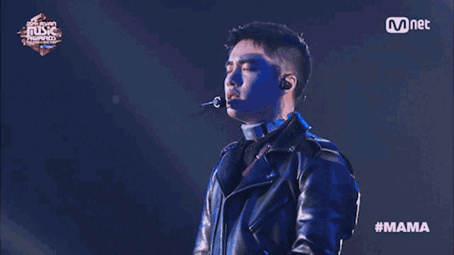 a man singing into a microphone at a music awards