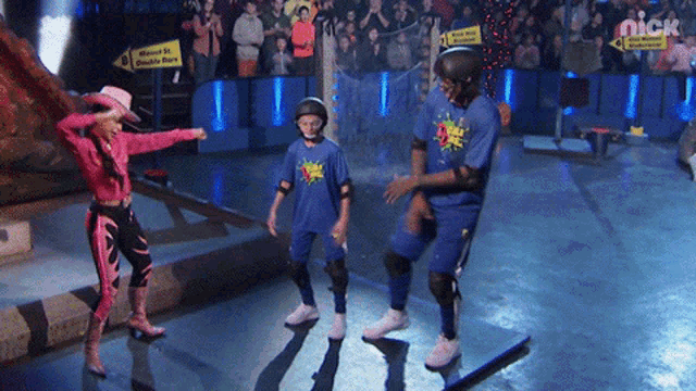 a girl in a pink cowboy outfit is standing next to a man in a blue shirt that says nick on it