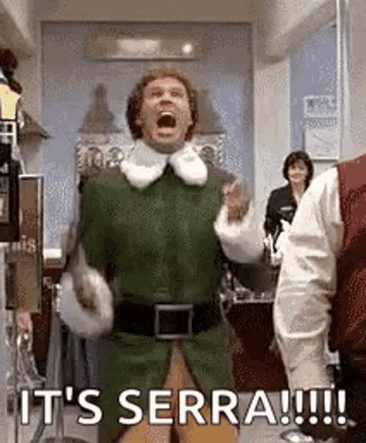 a man in a green elf costume is shouting it 's serra !