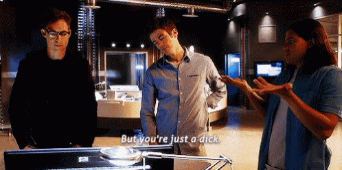 a man and a woman are standing next to each other in a room and the man says but you 're just a dick