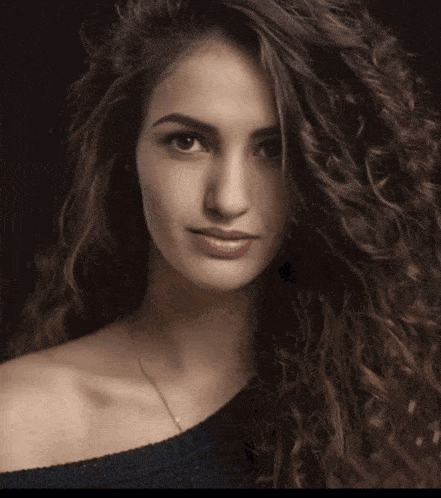 a close up of a woman 's face with a blurred background