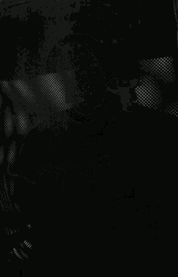 a black and white photo of a person standing in a room .