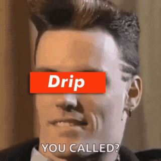 a man in a suit and tie is wearing a drip sticker on his eye .