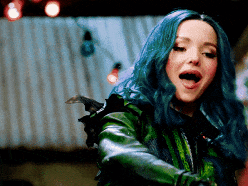 a woman with blue hair wearing a green leather jacket