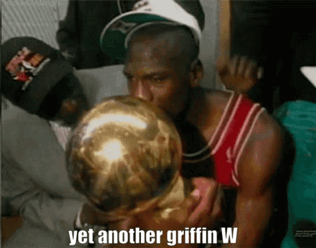 a man kissing a trophy with the words yet another griffin w