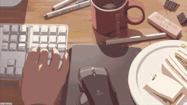 a person is typing on a keyboard with a logitech mouse