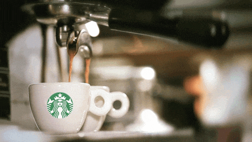 a starbucks cup is being poured into a coffee maker