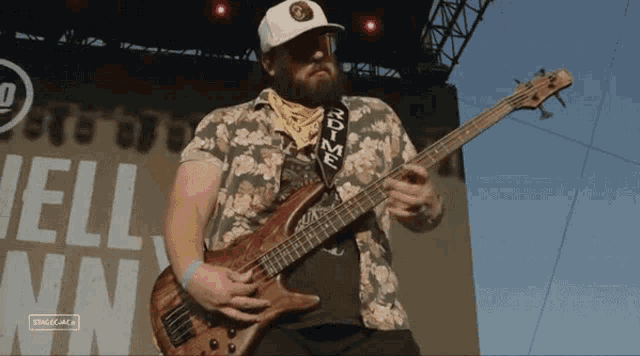 a man playing a bass guitar with a strap that says " rdtime "