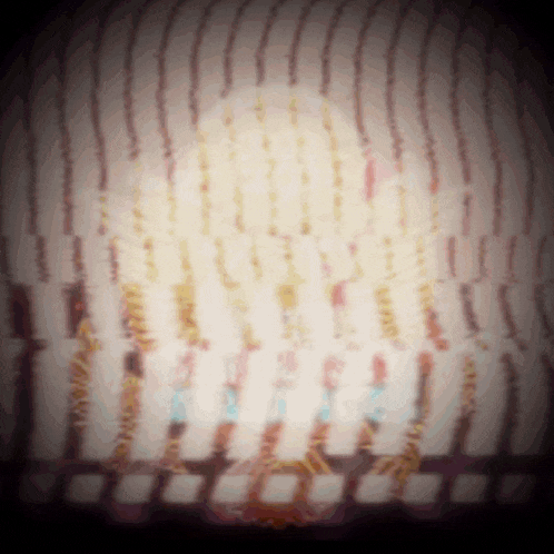 a blurred image of a birthday cake with candles and confetti