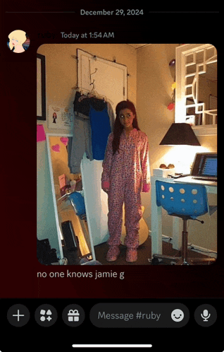 a phone screen shows a picture of a girl standing in front of a mirror