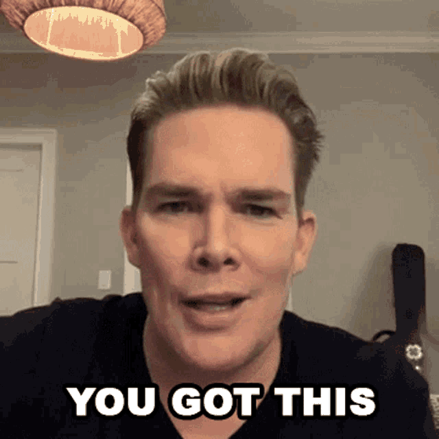 a man says " you got this " in front of a guitar case