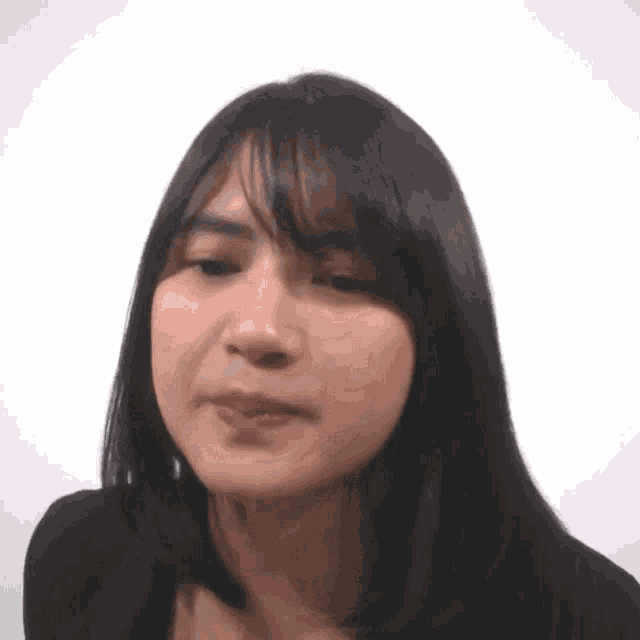 a close up of a woman making a funny face with her mouth open .