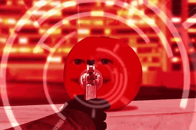 a person is holding a gun in front of a red smiley face ..