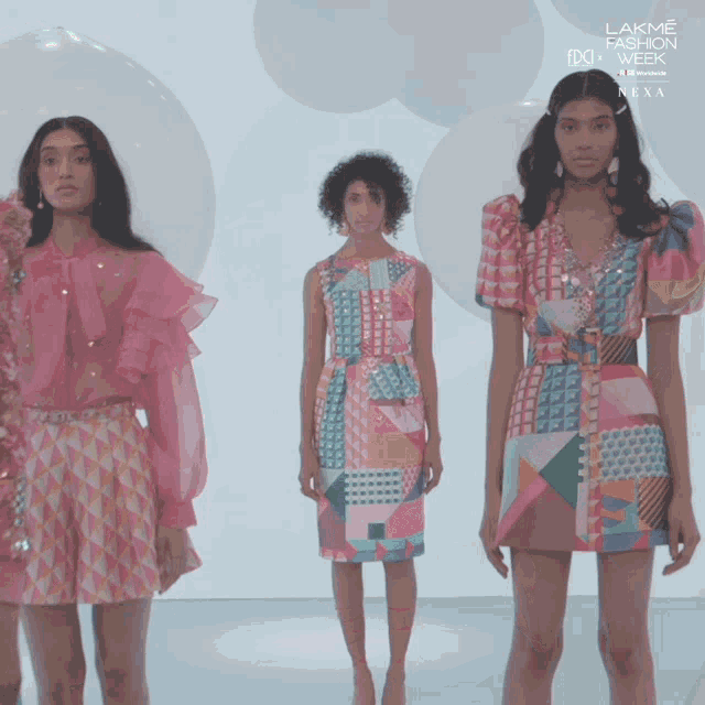 three models wearing colorful dresses for lakme fashion week next