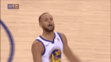 a basketball player wearing a golden state warriors jersey is standing on a basketball court .