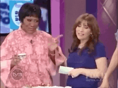 two women are standing next to each other on a tv show with the word tyra on the bottom right